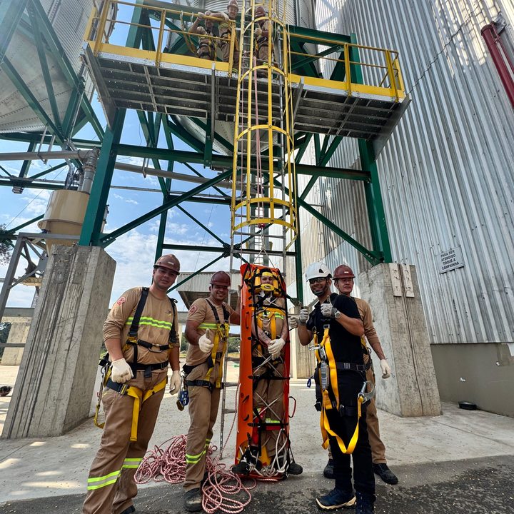 Equipe de resgate em silo industrial com maca